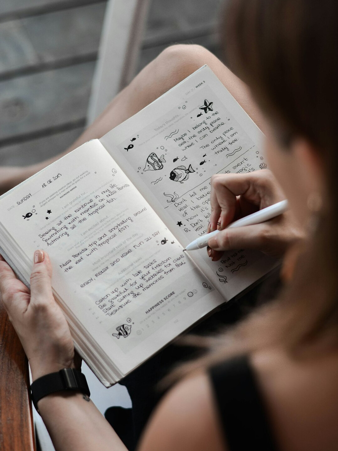 person writing in journal